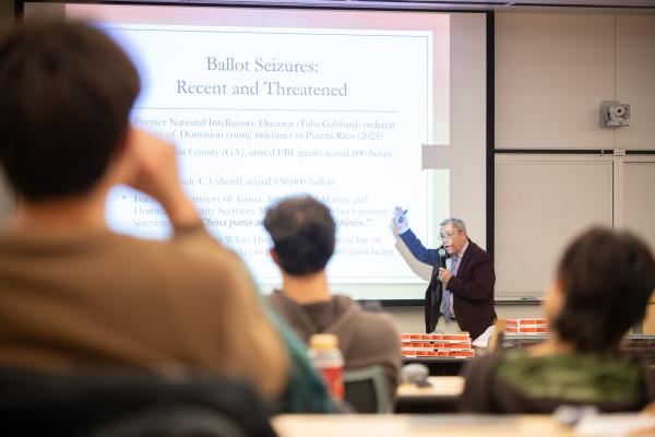 Political Science Department Chair Tony Robinson talks to classroom