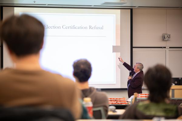 Political Science Department Chair Tony Robinson talks to classroom