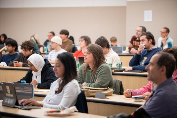 Close shot of students sitting and listening intently. 
