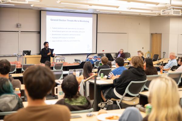 CU Denver Alum and Denver Elections Clerk Paul Lopez talks in classroom - wide shot