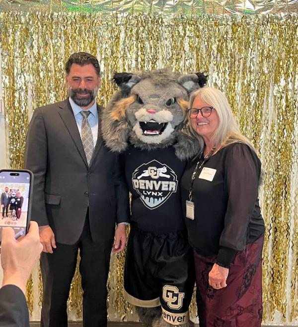 Rich Allen and Laura Argys pose for a photo with Milo, the CU Denver Mascot