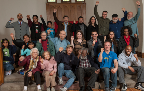 Romero Troupe actors and actresses gather with fists in air