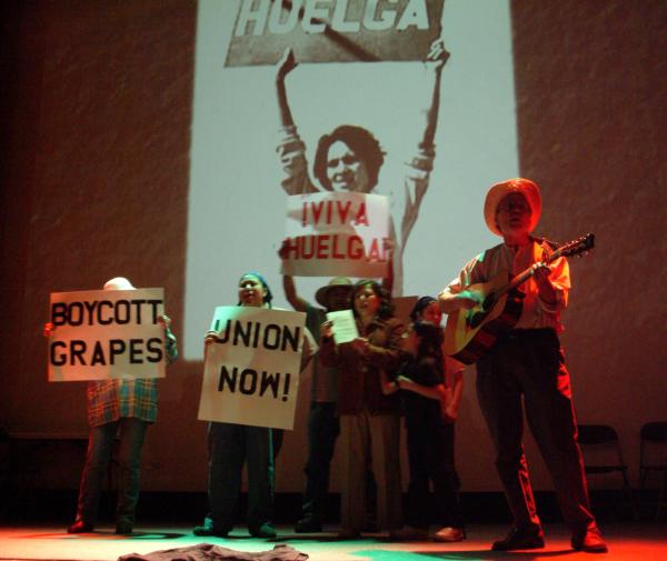 Romero Troupe actors and actresses stand with Union Now signs