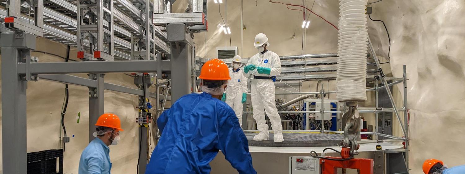 scientists work on the SuperCDMS dark matter lab