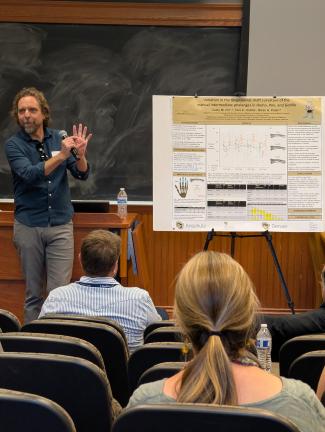  Dr. Caley Orr  presents his poster to attendees