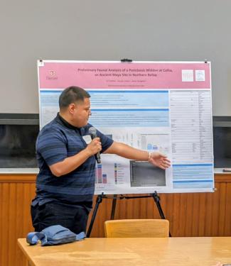 MA student SJ Chavez  presents his poster to attendees