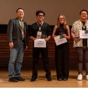 Dagoberto Grijalva-Flores stands with officials and fellow award winners at the NOS award ceremony 