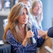 woman speaking into mic at event