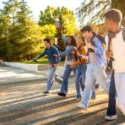 students walk together laughing on college mall