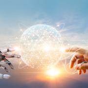 image of robotic hand reaching out to human hand