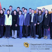 A group of approximately 30 visiting scholars and administrators from U.S. and Chinese universities stand together in front of a colorful mural at the University of Colorado Denver. They are posed in a single row, dressed in professional attire, smiling toward the camera. The CU Denver and Department of Communication logos appear at the bottom of the image along with the event location and date.