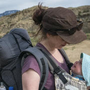 mother holds child in the mountains