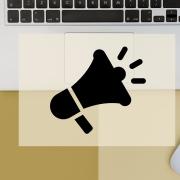 a bullhorn icon over a computer to symbolize marketing and communications