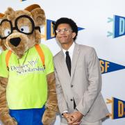 Michael Bourne, CU Denver student in International Studies and Latin American Studies, poses with the Denver Scholarship Foundation mascot and other speaker.