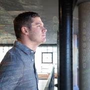 Philip looks out a window with data flying past him