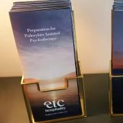 Psilocybin brochures sit in a stand on a table