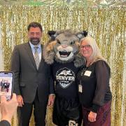 Rich Allen and Laura Argys pose for a photo with Milo, the CU Denver Mascot