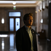 Denver Mayor Mike Johnson stands in a dark hallway