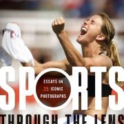 Kneeling female athlete celebrating win and clenching jersey in fist