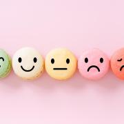 Macarons with smiley faces on them to indicate satisfaction level 