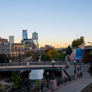Downtown Denver at dusk with the Cherry Creek Path and buildings in the distance