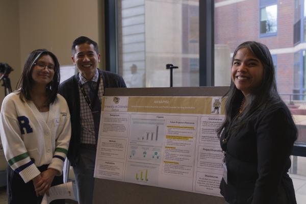 A CLAS faculty member stands by their research at the 2024 CLAS MixTape Celebration.