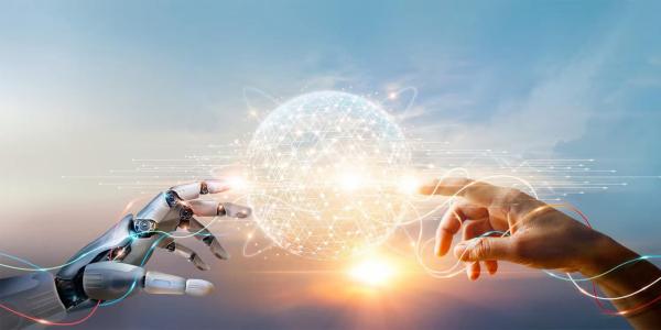 Robot hand and human hand touching lighted sphere