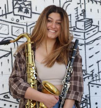 Picture of Sosy Kokozian, headshot, holding musical instruments