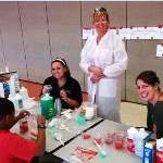 CU Denver Biology Student Club doing science experiments with middle school students