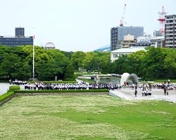 Japanese school children visiting the Cenotaph at the Memorial Monument for Hiroshima, City of Peace.