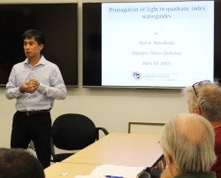 Presenting with confidence, Neil Rebolledo defends his master's thesis.