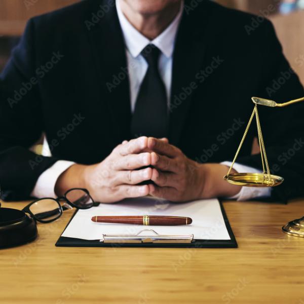 lawyer resting arms on desk 