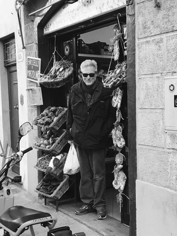 Professor Harvey Bishop in front of a shop in black and white