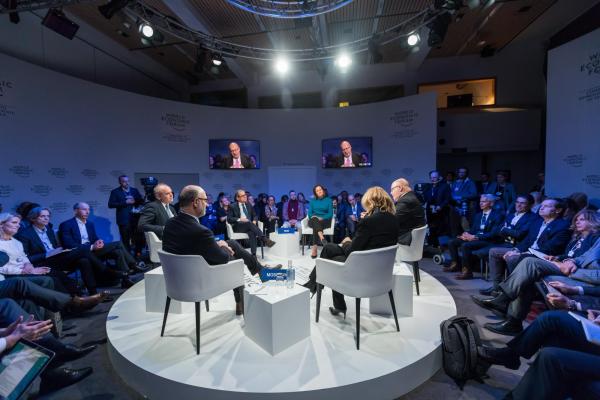 people sitting on debate stage 