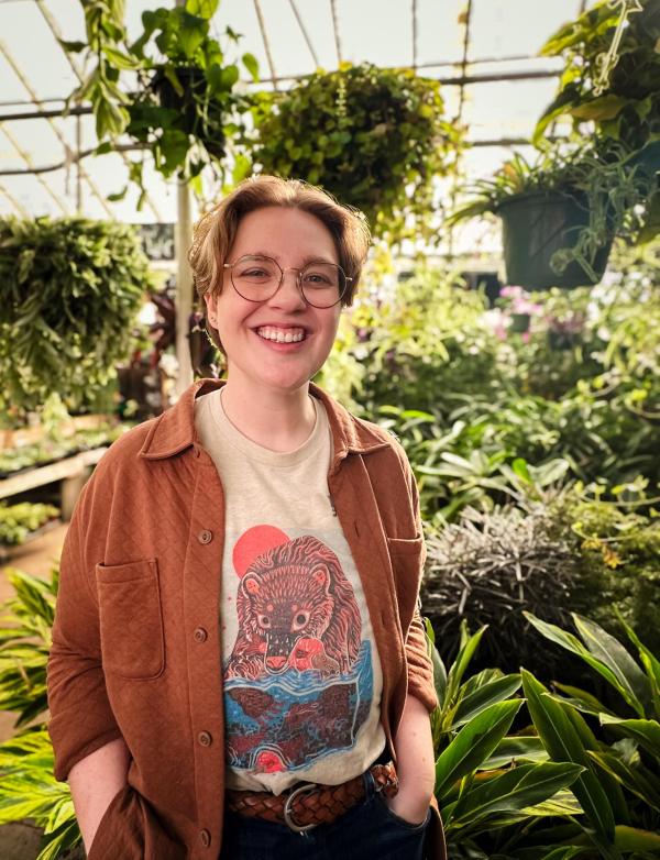 Donalyn White smiles with many plants in the background