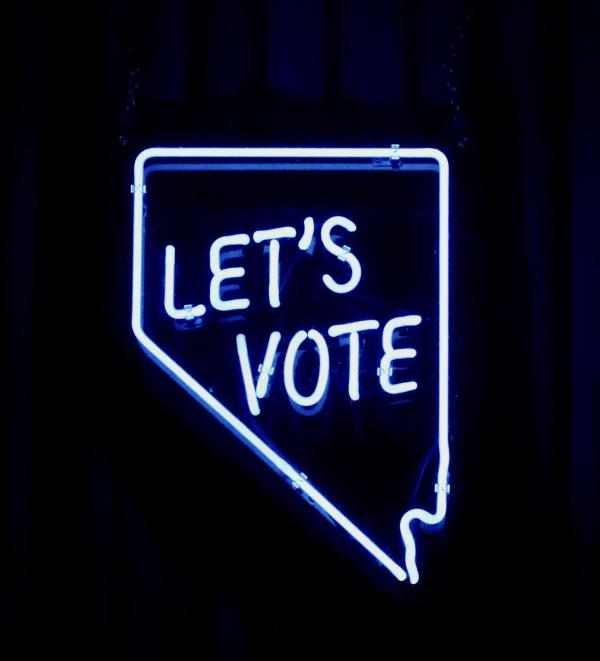 Neon lights that read “Let’s vote”