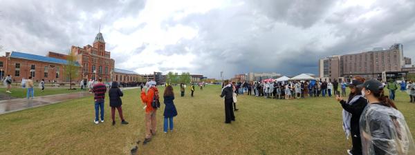 Auraria protestors on the quad linking arms facing police grouped in front of the Tivoli