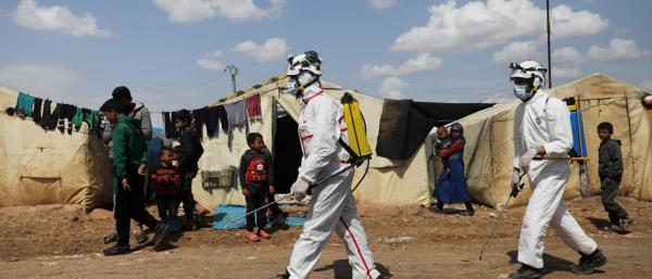 Members of the Syrian Civil defence sanitize the Bab Al-Nour internally displaced persons camp, to prevent the spread of coronavirus disease (COVID-19) in Azaz, Syria on 26 March.