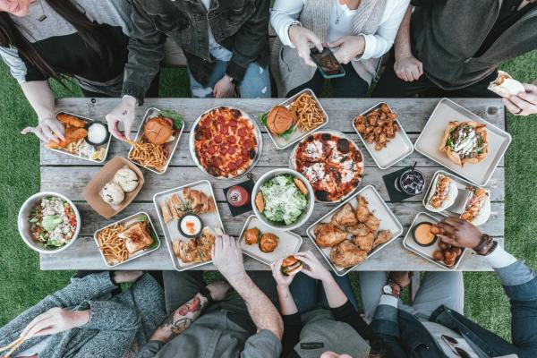 Table with food and hands eating