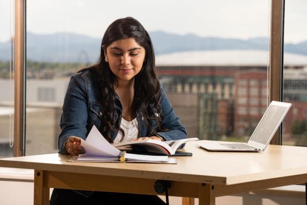 Student reading at a desk