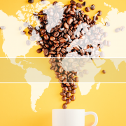 Coffee cup with coffee beans pouring into it against a yellow background. Overlay of world map with indicators showing where coffee is grown in the world.