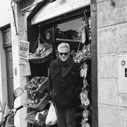 Professor Harvey Bishop in front of a shop in black and white