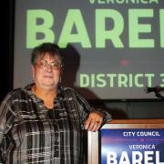 Veronica Barela stands next to podium reading "City Council Veronica Barela District 3" Photo by Joe Contreras