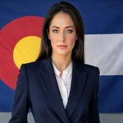 Amanda Calderon in front of Colorado Flag
