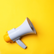 Yellow background with megaphone facing to the right