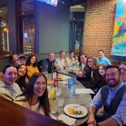 Group of Students smiling at a common dinner table