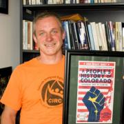 Dr. James Walsh with Poster A People's History of Colorado - Photo: Ryan Egloff· The Sentry