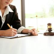 Woman writing near a gavel