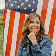 Karen Breslin in front of American flag 
