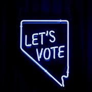 Neon lights that read “Let’s vote”